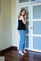 A woman standing in front of a door in a room.