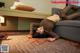 A woman laying on the floor in a hotel room.